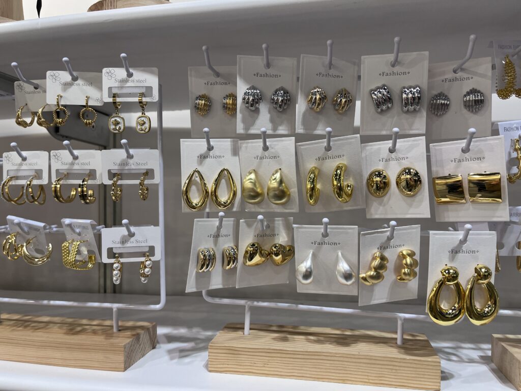 Close-up of golden earrings by DongGuan HaoSen at Fashion InStyle 2025